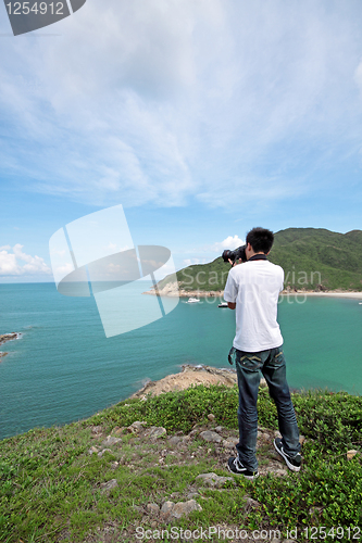 Image of photographer takes a photo of the landscape 