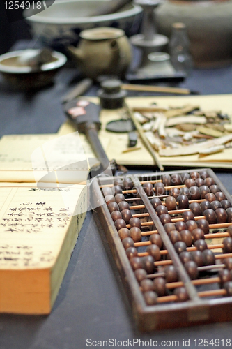 Image of abacus and book on the table in a chinese old shop 