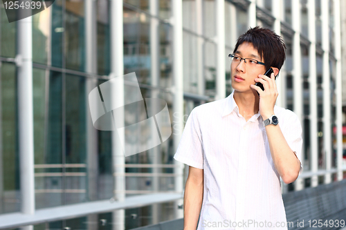 Image of businessman talks with a mobile phone 