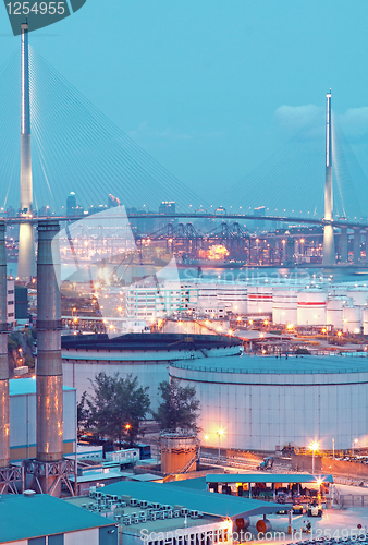 Image of gas container and bridge at night