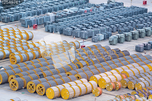 Image of electricity cable on wooden spools and many transformer on the f