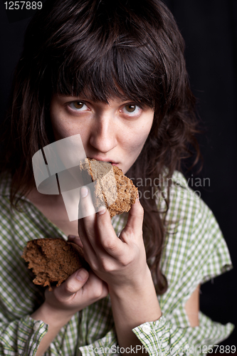 Image of beggar woman eating bread 