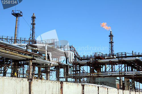 Image of torch is lit on tower refinery