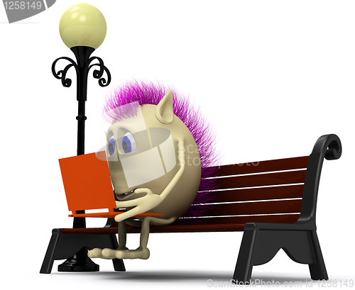 Image of Haired puppet using laptop on brown bench