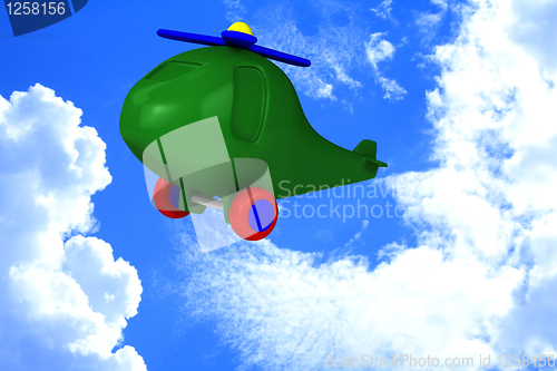 Image of Green helicopter with tires fly in sky