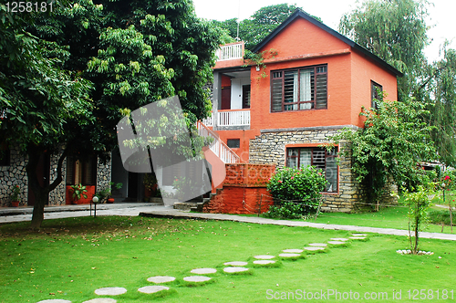 Image of Red house with green meadows