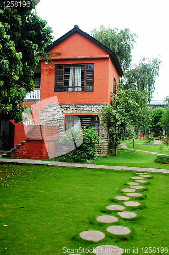 Image of Red house with green meadows