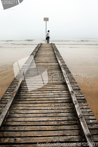 Image of Teenage girl on old sea pier