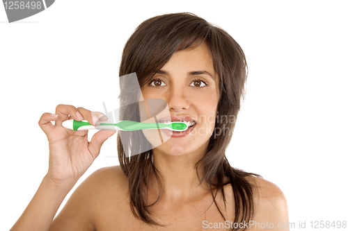 Image of Young woman brushing her teeth