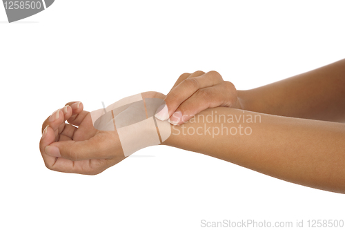 Image of human hand measuring arm pulse