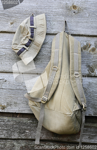 Image of Khaki Hat and Backpack on the Wooden Wall