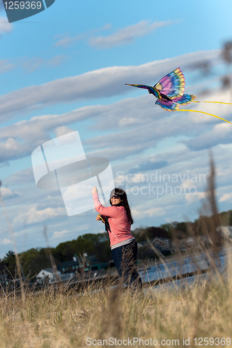 Image of Woman Flying a Kite at the Beach