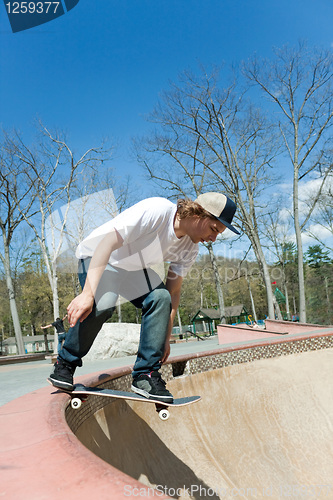 Image of Skateboarder Falling Into the Bowl at the Skate Park