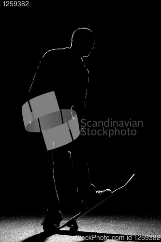 Image of Rim Lit Skateboarder Silhouette