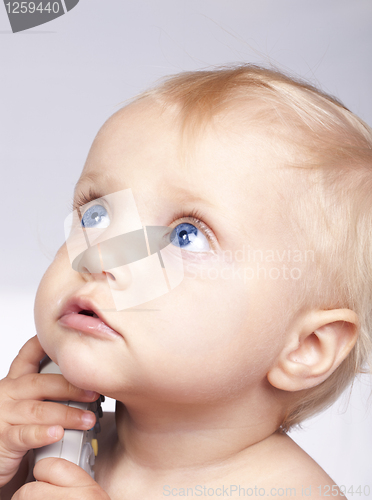 Image of Baby play with remote control