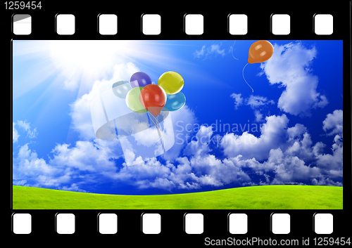 Image of Filmstrip with color balloons in the dark blue sky