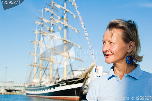 Image of The woman on a background of a sailing vessel