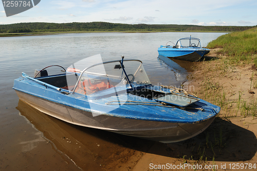 Image of two motor boats on the shore