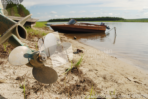 Image of screw propeller, motor boats on the shore