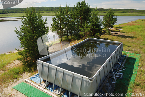 Image of inflatable pool in the camp by the river