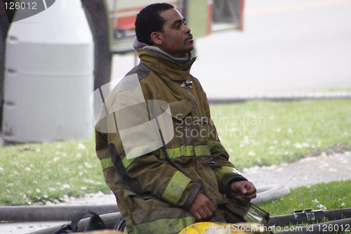 Image of fireman kneeling