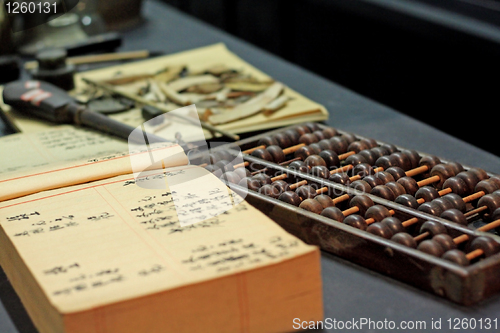 Image of abacus and book on the table in a chinese old shop 