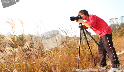 Image of photographer taking photo in country side 