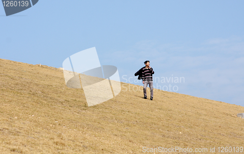 Image of man walking on the mountain