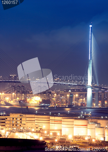 Image of gas container and bridge at night