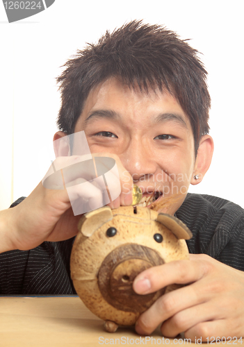 Image of asia man with piggy bank 