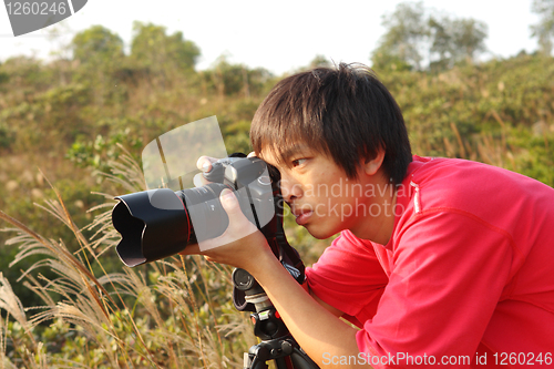 Image of photographer taking photo in country side 