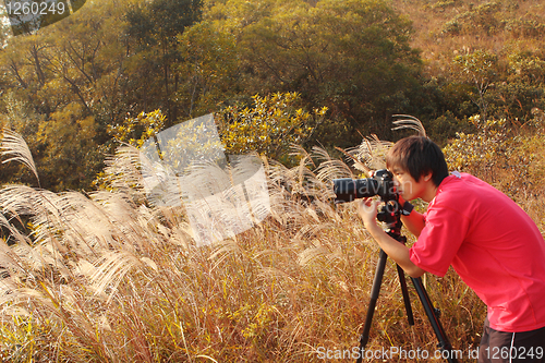 Image of photographer taking photo in country side 