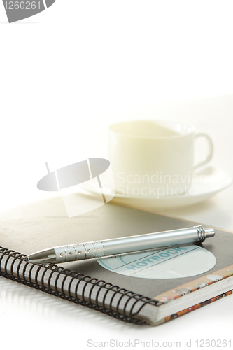 Image of Pen on a white paper with cup of coffee