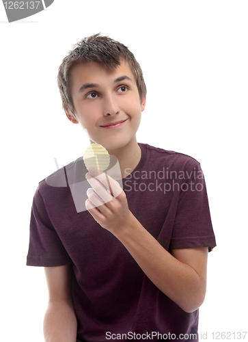 Image of Boy with potato crisp looking sideways