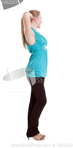 Image of A beautiful girl with long hair, straightens her hair.