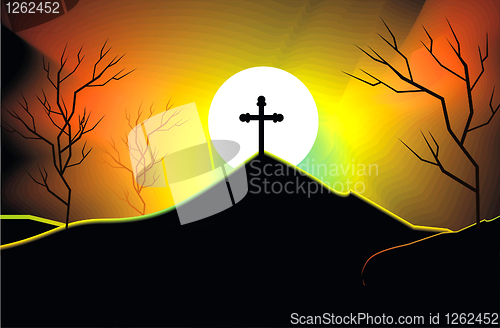 Image of cross on a mountain side at sunset