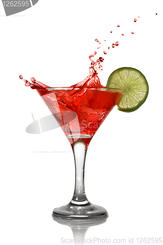 Image of Red cocktail with splash and lime isolated on white