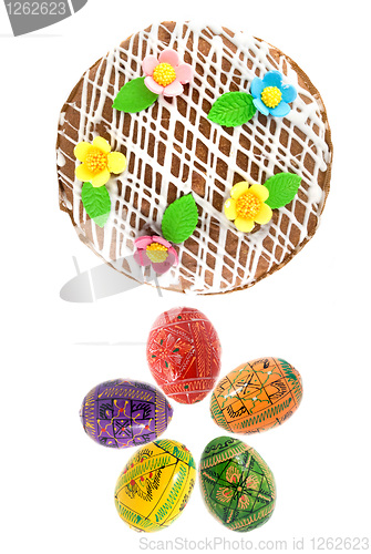 Image of top view of easter eggs and cake isolated on white