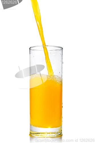 Image of orange juice poring into glass isolated on white