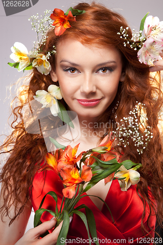 Image of Portrait of beautiful woman with spring flowers 