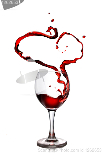 Image of Heart from pouring red wine in goblet isolated on white