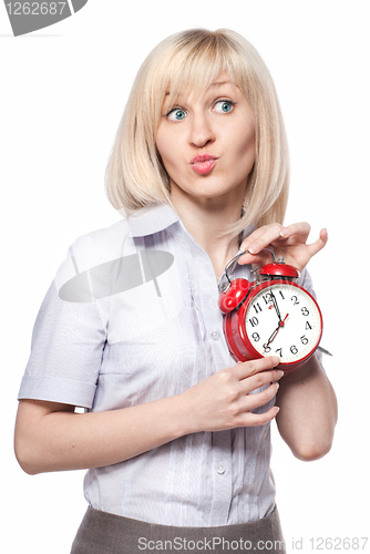 Image of A beautiful young woman with alarm clock isolated on white