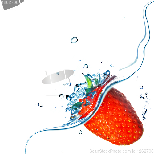 Image of Fresh strawberry dropped into water with splash isolated on whit