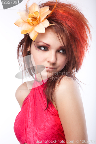 Image of Portrait of beautiful woman with spring flower in hair on white