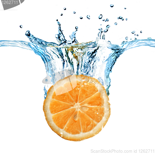 Image of Fresh lemon dropped into water with splash isolated on white