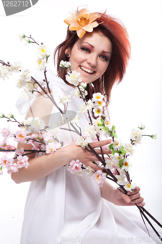 Image of Portrait of beautiful woman with spring flowers on white