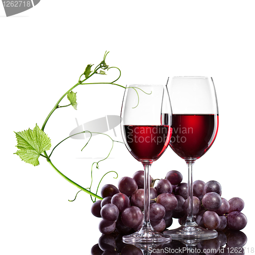 Image of Red wine in glasses with grape and rod isolated on white