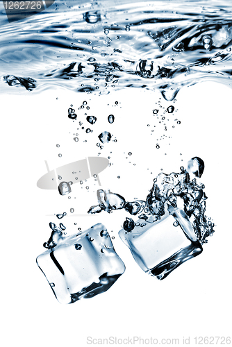 Image of ice cubes dropped into water with splash isolated on white