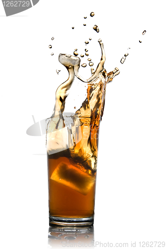 Image of Beautiful splash of cola with ice in glass isolated on white