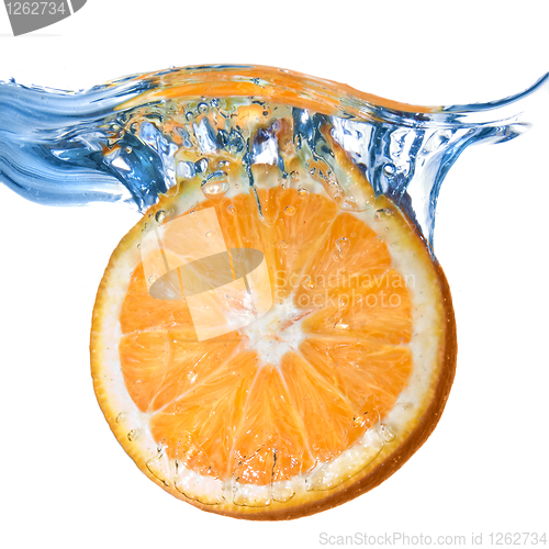 Image of Fresh orange dropped into water with splash isolated on white